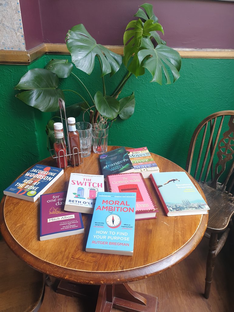 Display of a range of books on a wooden table